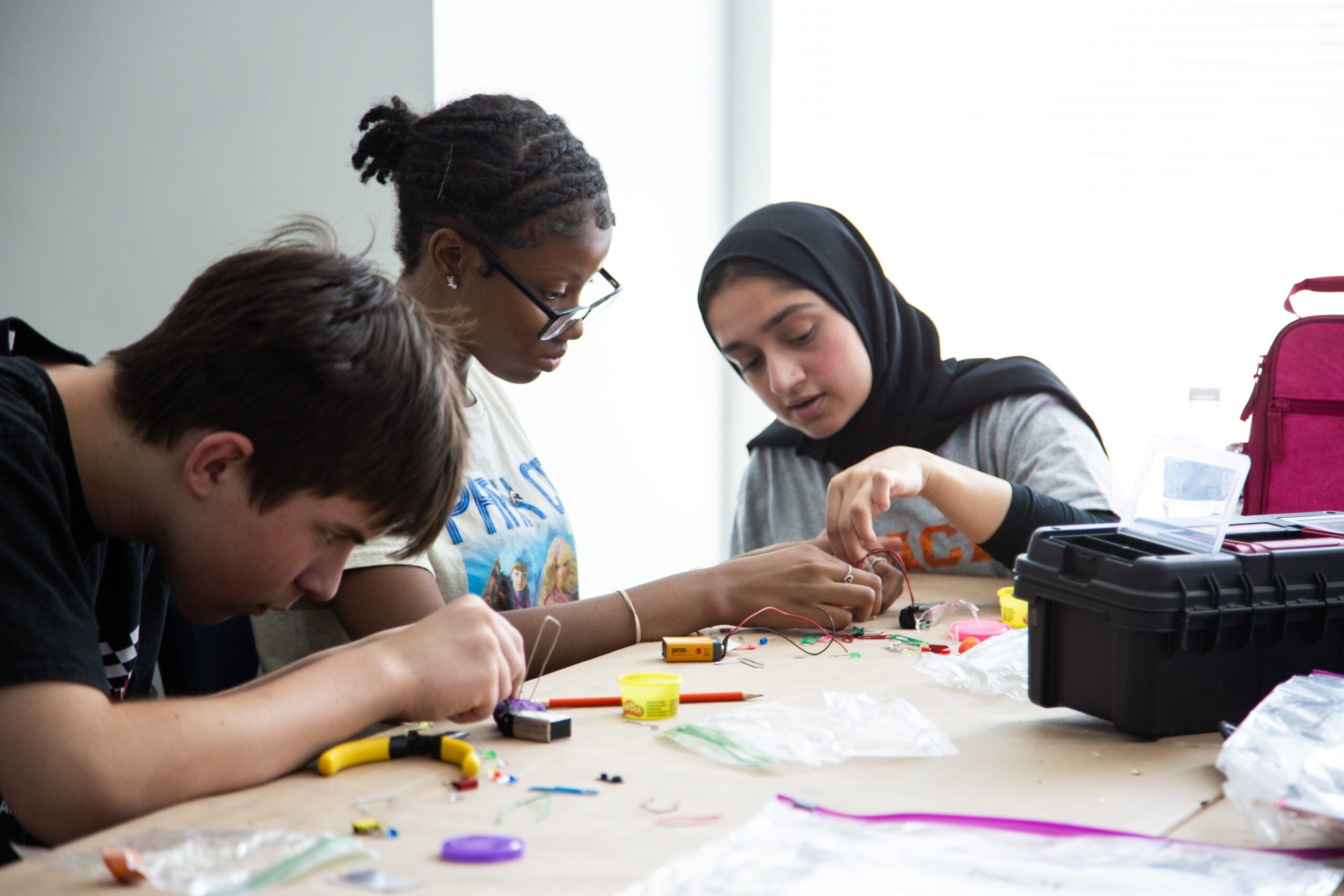 Photo of Students participating in a STEM camp building electronics