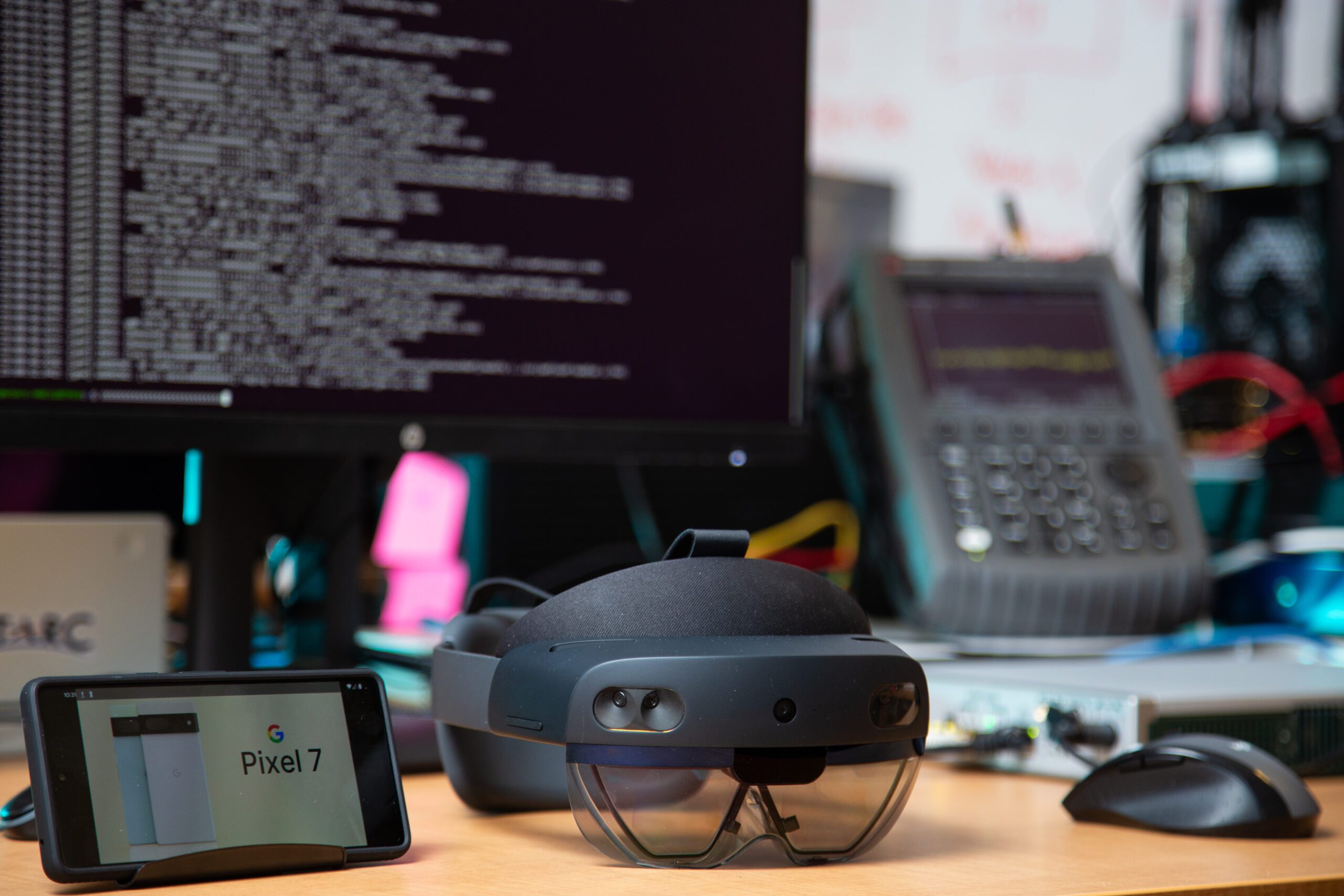 Photo of a Mixed Reality headset and Spectrum Sensing equipment in the background
