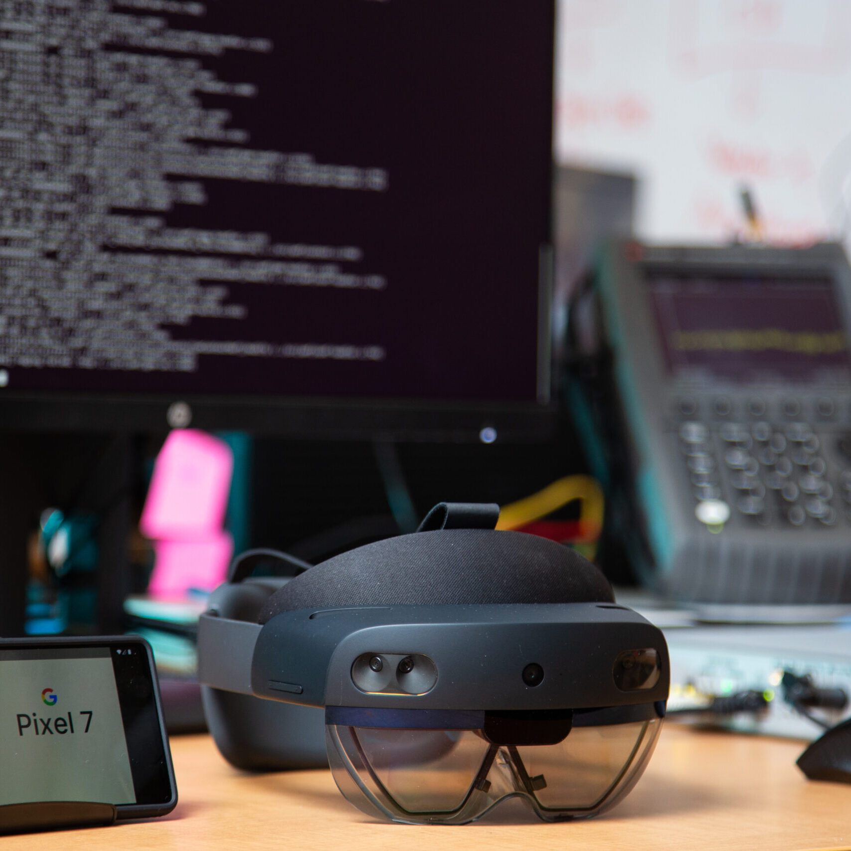 Photo of a Mixed Reality headset and Spectrum Sensing equipment in the background