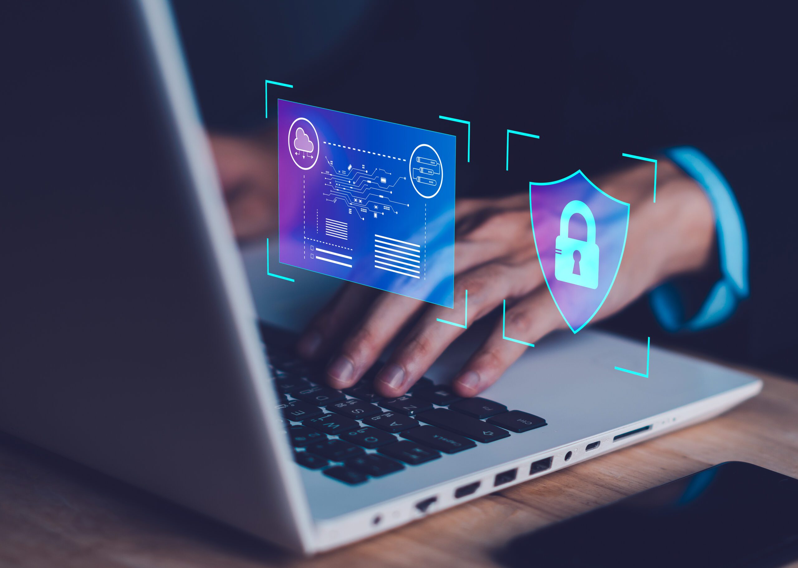 Image depicts a person using a laptop for cyber security.